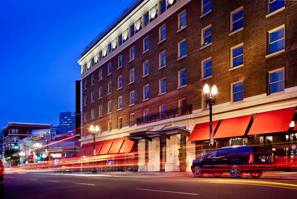 The Andaz's 1913 brick building at dusk, red awnings over F Street.