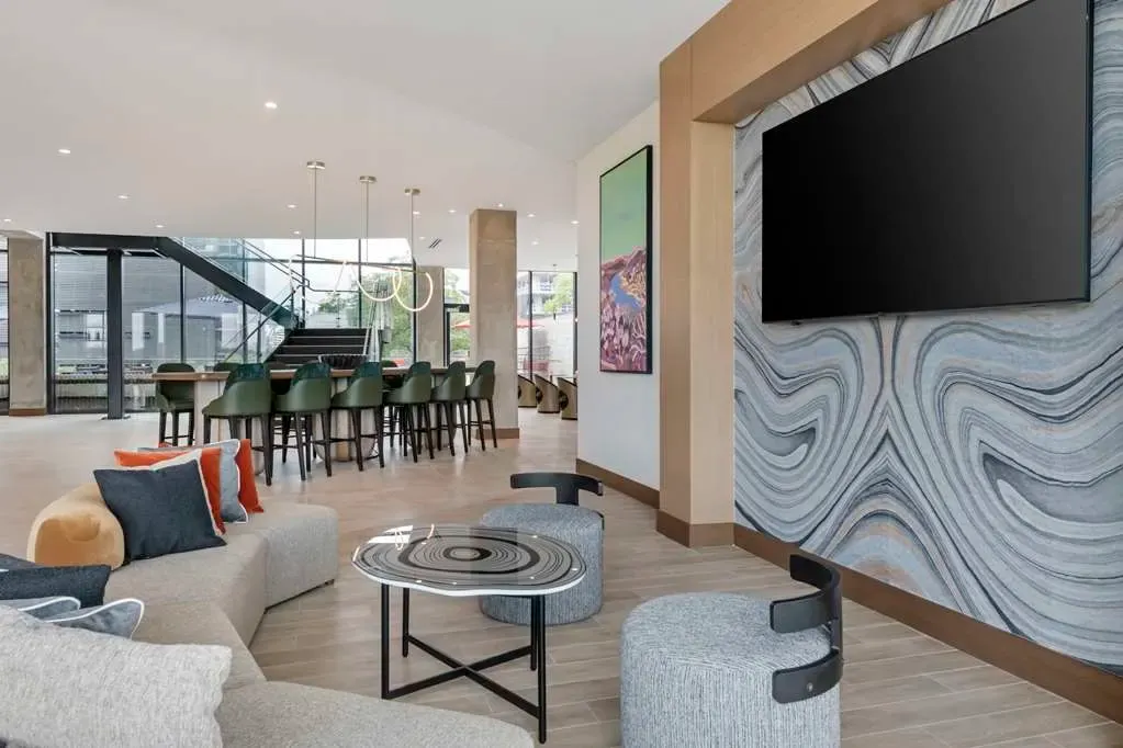 The lobby, a marbled feature wall beside low seating and the bar counter.