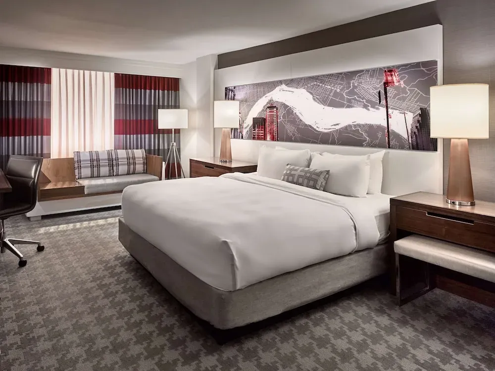 A king room in gray and red, a backlit city-map panel above the bed.