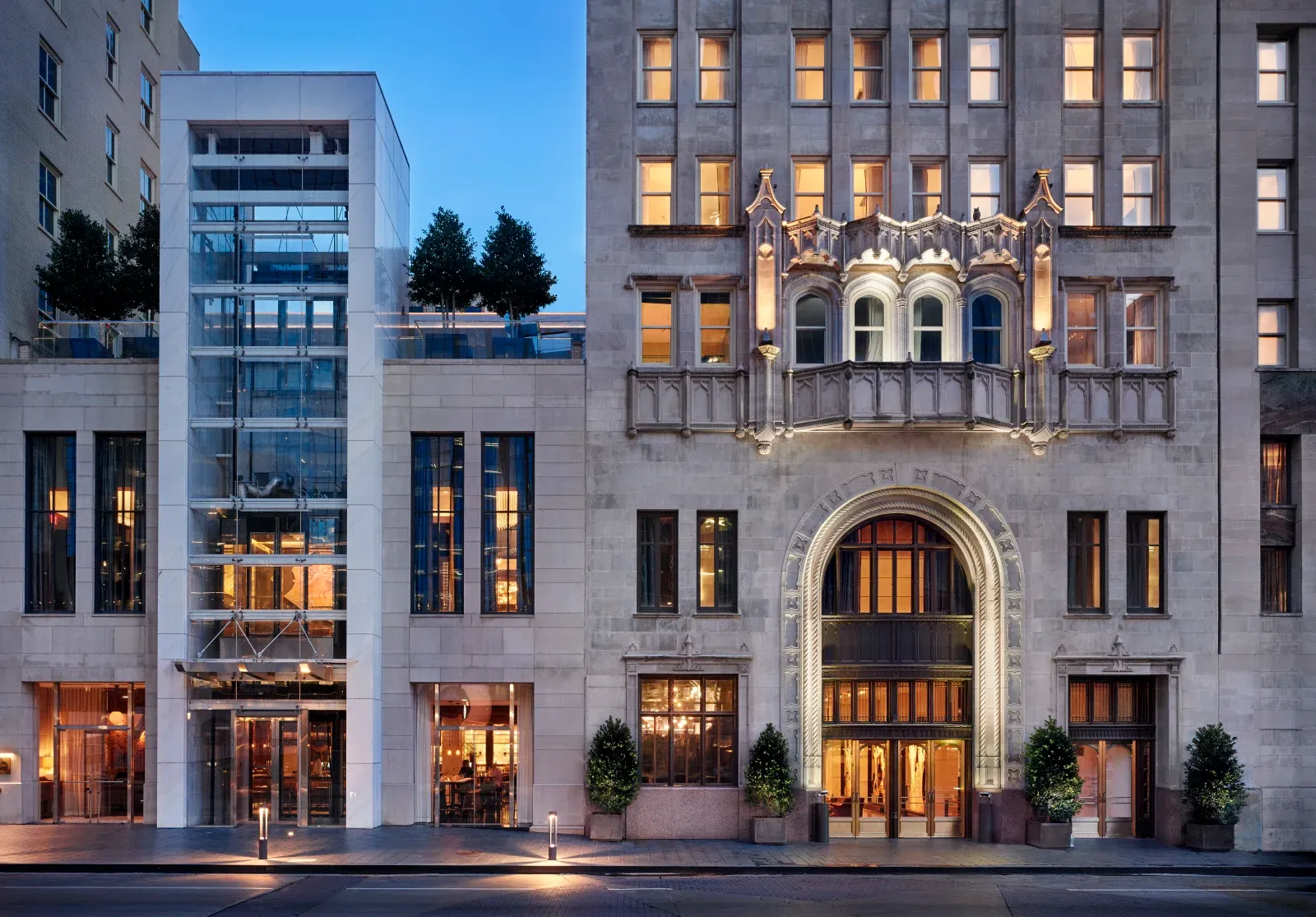 The Joule's Gothic-revival stone facade at dusk, a carved arch over the entrance.