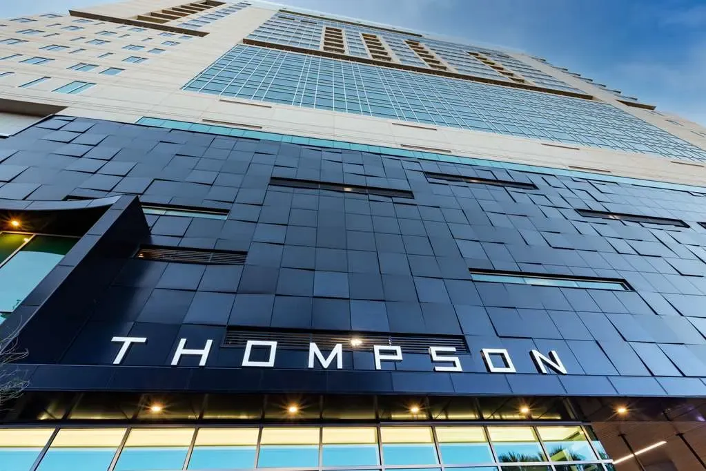 THOMPSON in white capitals across the dark tiled entrance.