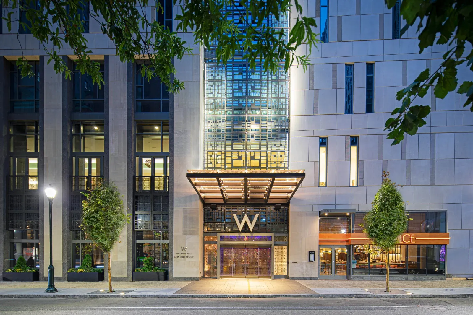 The Chestnut Street entrance at dusk, the lit W above the canopy.