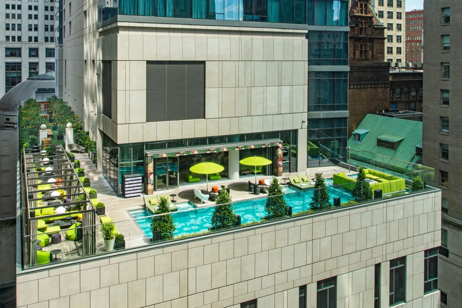 The WET deck from above, the pool running the roof's length between clipped hedges.